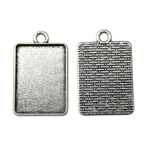 Textured Rectangular Cabochon Settings in Two Finishes held in hand for scale