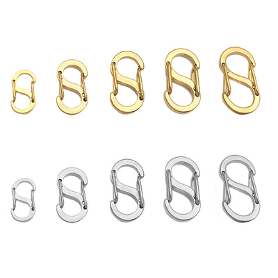 Gold-tone connector clasp jewelry findings arranged on a light background