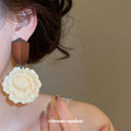 Carved Cream Flower Drop Earrings with Dark Wood Stud Tops view 3