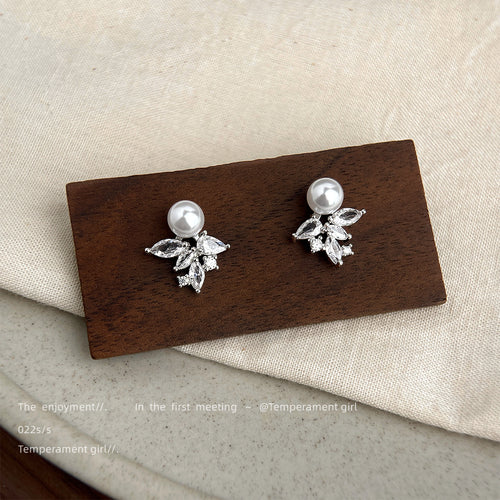 Silver pearl studs with ice crystal CZ clusters on wood block