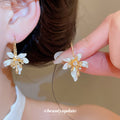 White Floral Hoop Earrings with Gold Tone Leaf Details view 1