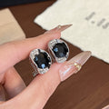 Black Oval Crystal Look Silver Tone Leverback Earrings view 1