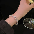 White Pearl Like Stretch Bracelet With Pink Heart Crystal Center view 2