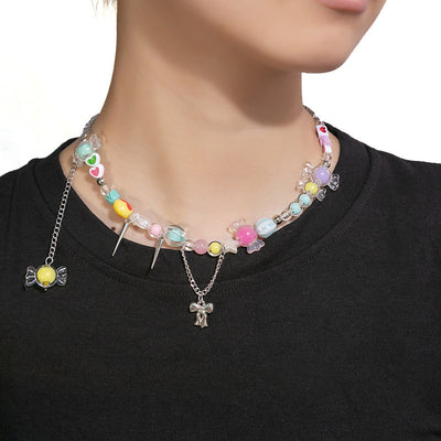 Candy bead necklace with lollipop and bow charms worn on black shirt