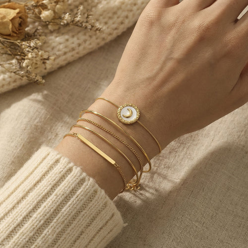 On-wrist view of crescent moon shell disc adjustable bracelets in main image 1.