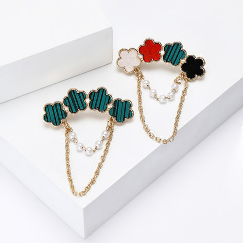 Close-up product view showing the colors and surface details of the four flower brooch