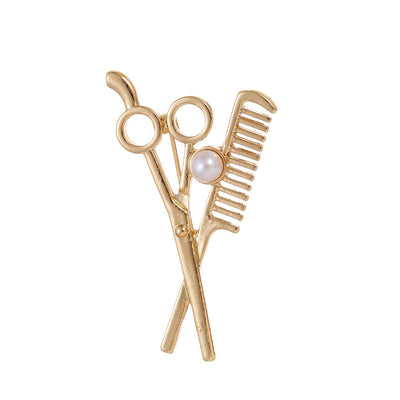 Front product view of the barber tools brooch pin in gold