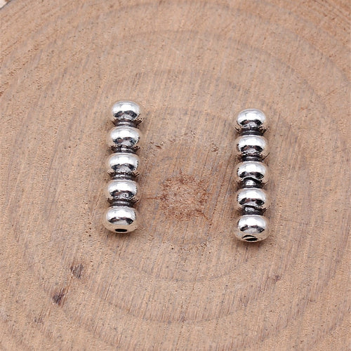 Stacked Ball Column Spacer Bead in Antique Silver Metal shown in image 2, highlighting a row of rounded beads forming a 