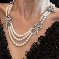 Triple Strand Faux Pearl Necklace With Crystal Bows view 3