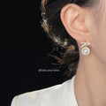 Gold Tone Clear Stone Bow And White Pearl Halo Drop Stud Earrings view 2