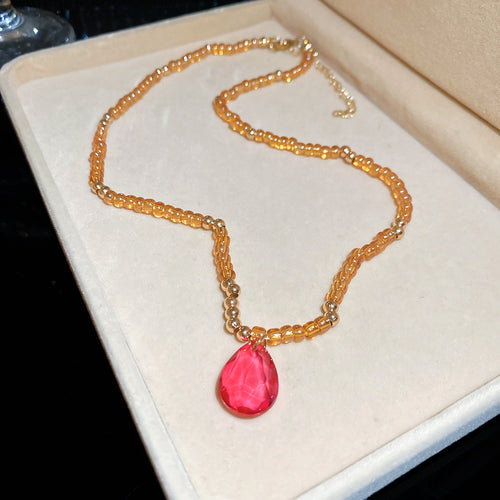 Amber bead magenta teardrop pendant necklace in cream jewelry box