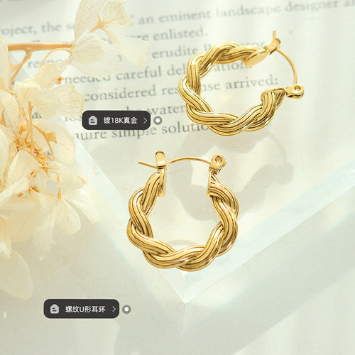 Pair of gold twisted rope U-hoops on acrylic tray with flower labels