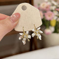 White Floral Drop Earrings with Gold Tone Petal Accents view 6