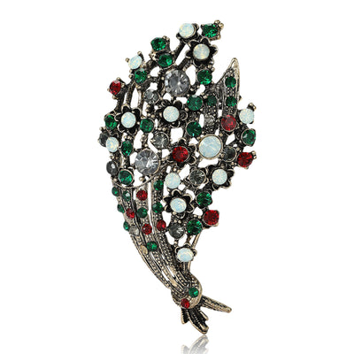 Front view of antique gold bouquet brooch with multicolor crystal flowers against a white background.