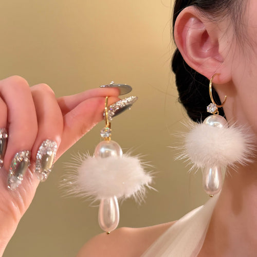 White Fluffy Pom Pom Hoop Earrings With Pearl Drops shown in worn view