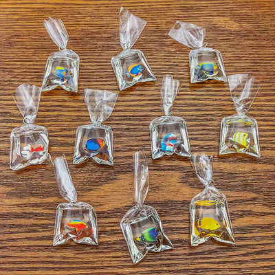 Clear goldfish charms arranged on a light background