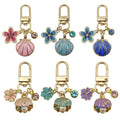 Starfish, Conch and Shell Charm Keychains Featuring Navy Flower Across 64 Variations view 1