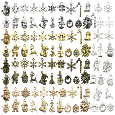 Gold-tone snowflake and bell charms arranged on a light background