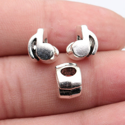 Antique Silver Sculpted Musical Note Large Hole Bead shown in hand