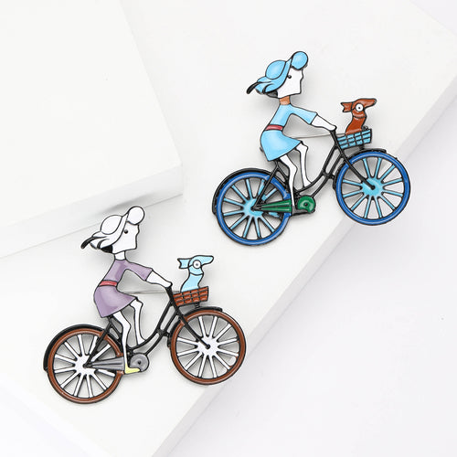 Purple and blue girl bicycle dog brooches side by side