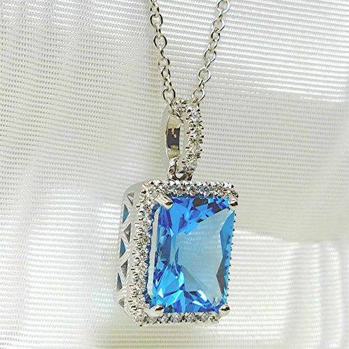 Angled side view silver aqua blue halo pendant showing stone depth