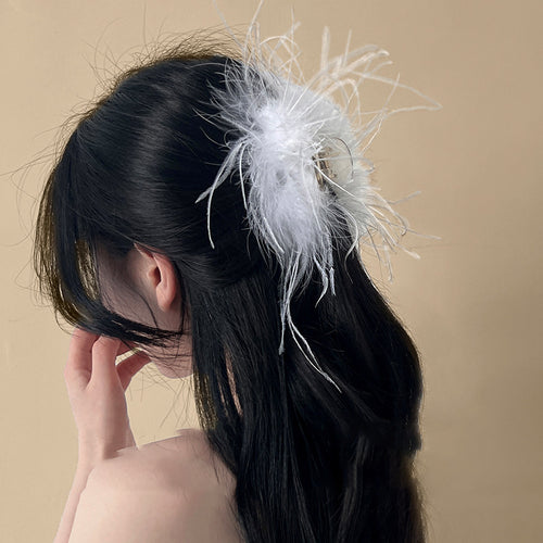 rounded hair claw covered with long black or white feathers shown in the first close product view