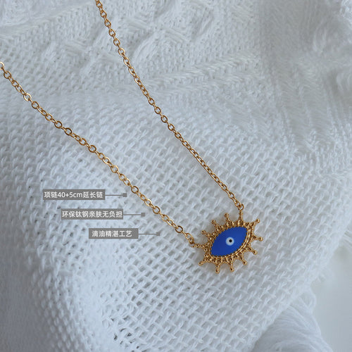 Close-up of blue enamel evil eye pendant with size and material labels