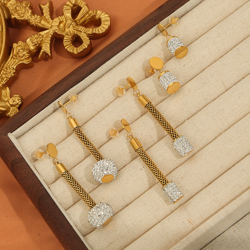 Assorted gold mesh and cylinder pave drop earrings in tray