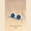 Gold Tone Blue Five Petal Flower And Red Center Stud Earrings view 1