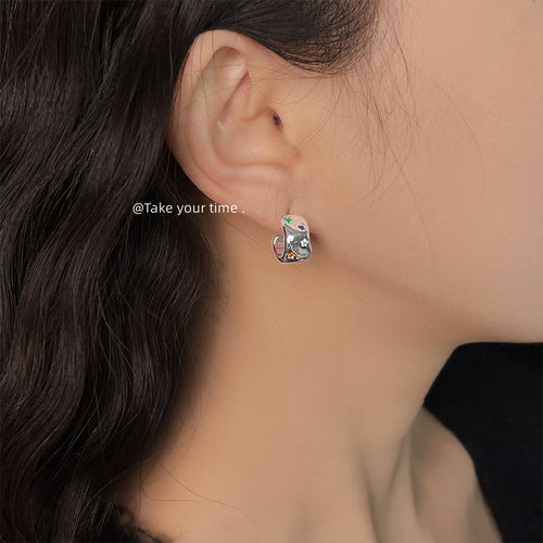 Silver chunky C hoop with multicolor CZ worn on ear profile