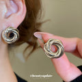 Sculptural Knot Stud Earrings In Gold And Silver Tones view 1