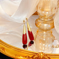 Deep Red Long Teardrop and Gold Tone Dangle Earrings view 2