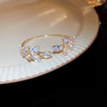 Gold Tone Leaf Crystal Open Bangle In Clear Pink Or Purple view 6