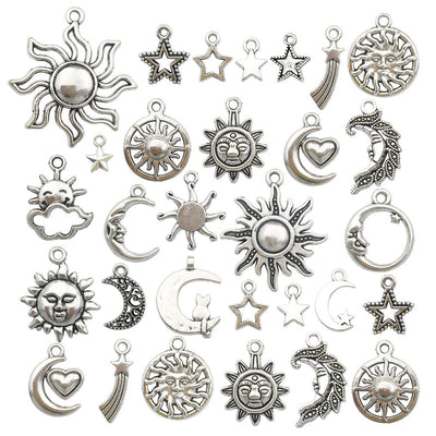 Metallic moon and sun charms arranged on a light background