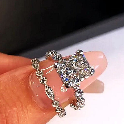 Second product view showing silver-tone cushion solitaire and marquise two-ring set