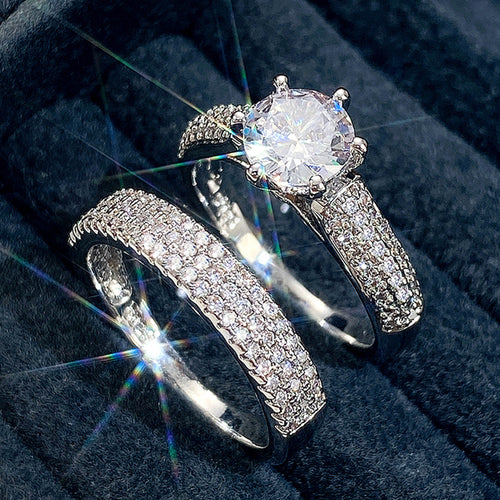 Silver Tone Round Stone Three Band Ring Set with Clear Stone Accents shown in styled view