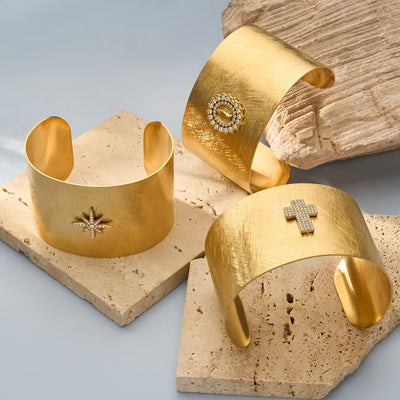 On-wrist view of broad brushed crystal motif open cuffs in main image 1.