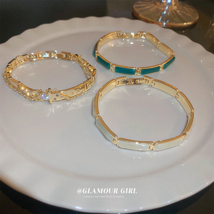 Gold Tone Belt Motif Link Bracelet With Clear Crystal Details