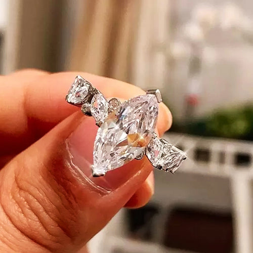 Silver marquise CZ ring front face close-up between fingers