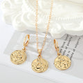 Gold Tone Embossed Cherub Coin Necklace and Huggie Earrings view 1