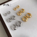 Polished Oval Huggie Hoop Earrings In Gold Silver And Three Sizes view 1