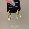 Pair of Metal Tone Gold Tone Sculpted Oval Drop Hoop Earrings view 2