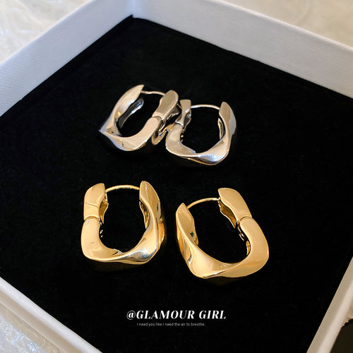 Product view of sculpted square hoop earrings in gold and silver tone