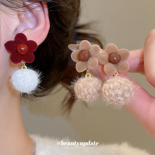 Main image 2 showing two floral drop designs with fluffy pom-poms in red and white or beige and tan, arranged detail vie