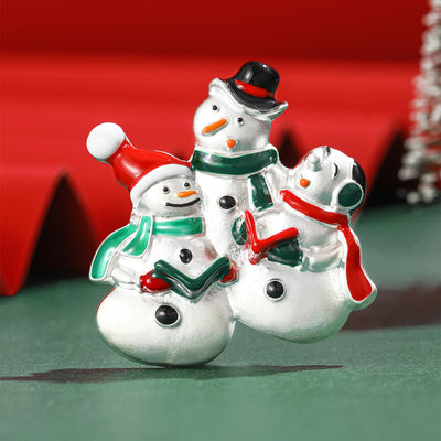 Front product view of the three snowman family brooch on a light background