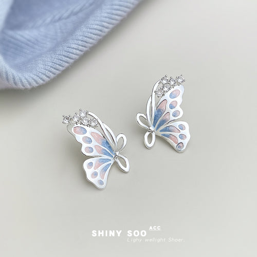 Silver-tone pastel-blue pink-butterfly stud earrings in the first product display.