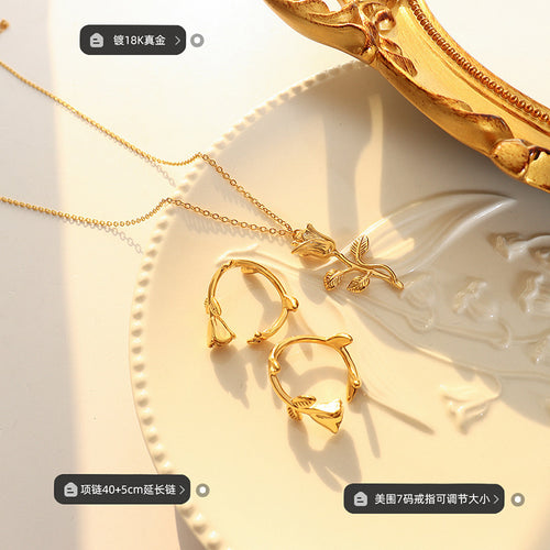 Still life of rose pendant necklace and rose open rings with size labels