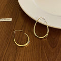 Polished Teardrop Hook Earrings In Gold And Silver view 6