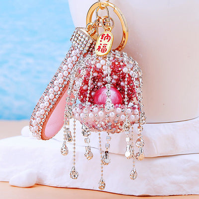 Main image 1 shows a supplied presentation of long pearl curtain shell keychains with visible attached key hardware.