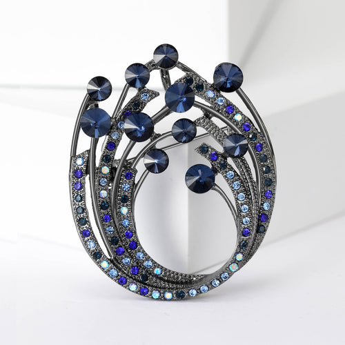 Open spiral wreath formed from curved rows of beads and crystals brooch styled display